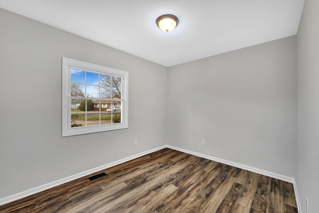 unfurnished room featuring dark wood-type flooring