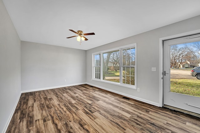 spare room with ceiling fan and wood-type flooring