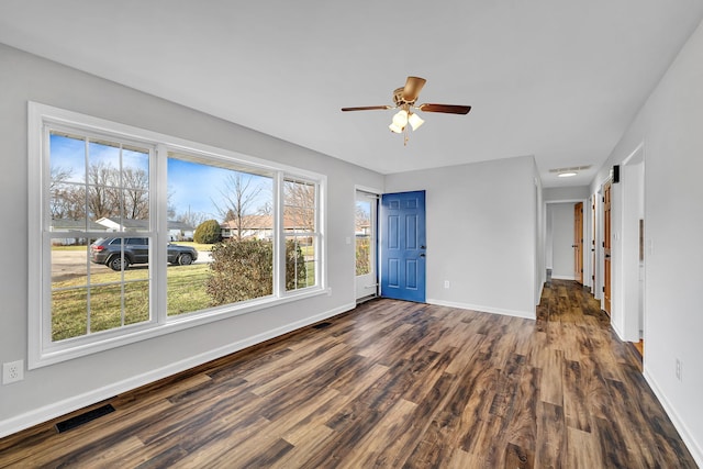 unfurnished room featuring ceiling fan and dark hardwood / wood-style flooring