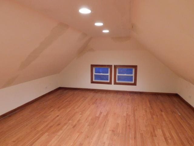 bonus room featuring light hardwood / wood-style flooring and lofted ceiling