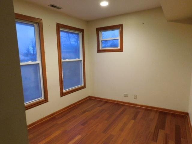 unfurnished room featuring dark hardwood / wood-style flooring