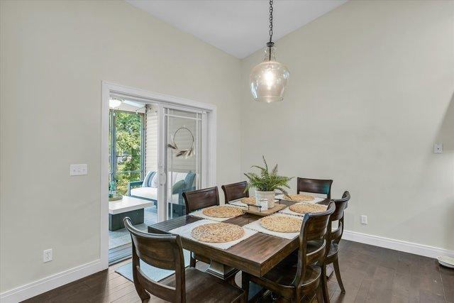 dining room featuring dark hardwood / wood-style floors and lofted ceiling