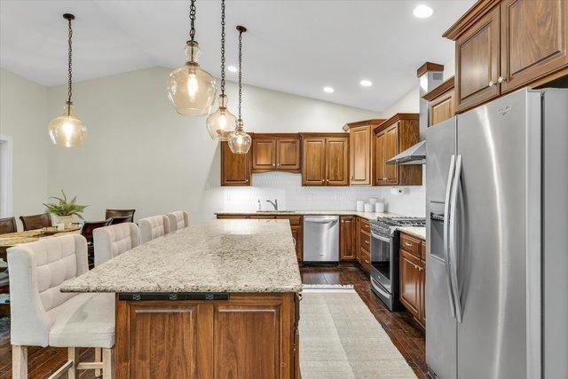 kitchen with appliances with stainless steel finishes, a center island, and pendant lighting