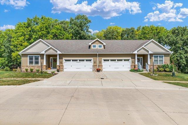 craftsman house with a garage and a front lawn