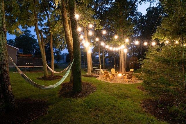 view of yard with a trampoline and a fire pit