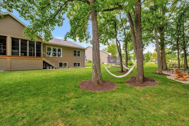 view of yard featuring a trampoline and a sunroom