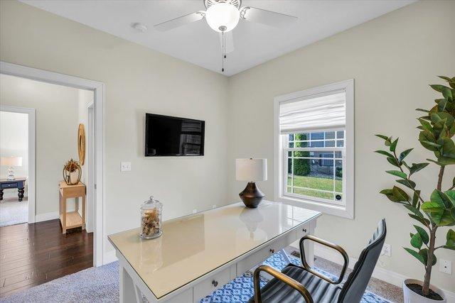 home office featuring dark hardwood / wood-style flooring and ceiling fan