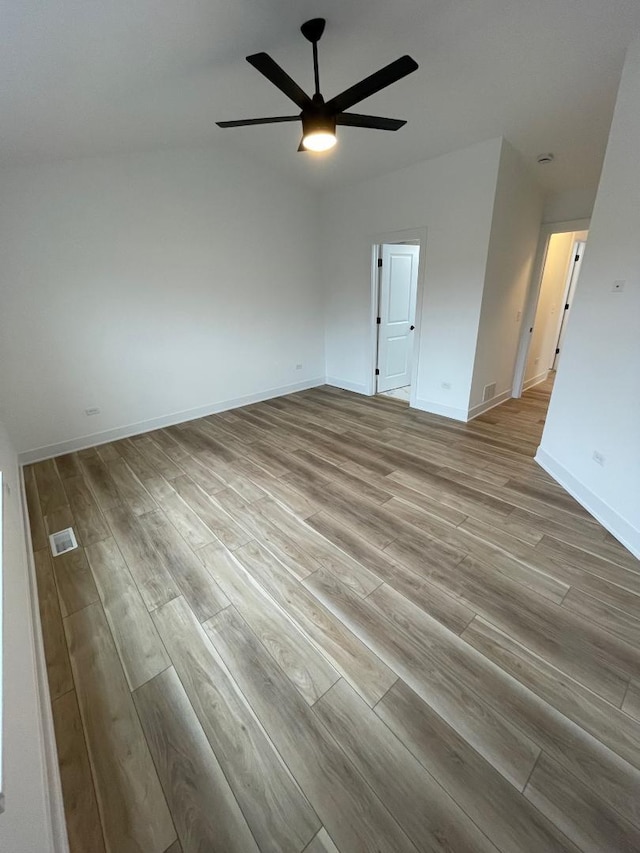 empty room with ceiling fan and light wood-type flooring