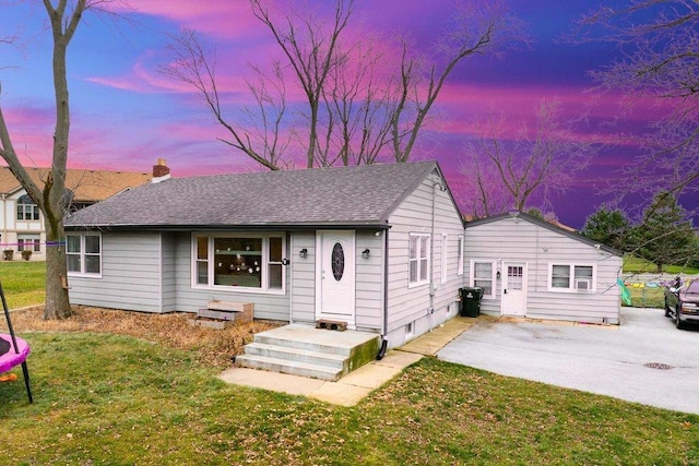 ranch-style house featuring a lawn