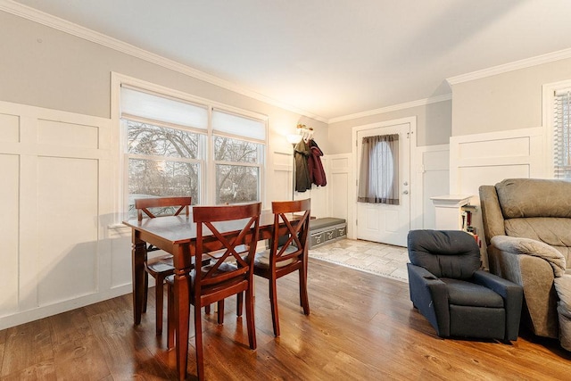 dining room featuring wood-type flooring and crown molding