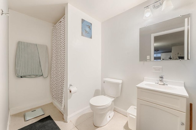 bathroom with tile patterned flooring, vanity, and toilet