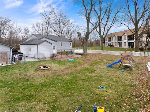 view of yard with a playground and an outdoor fire pit