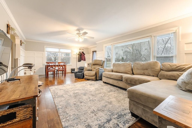 living room featuring crown molding, dark hardwood / wood-style flooring, and ceiling fan