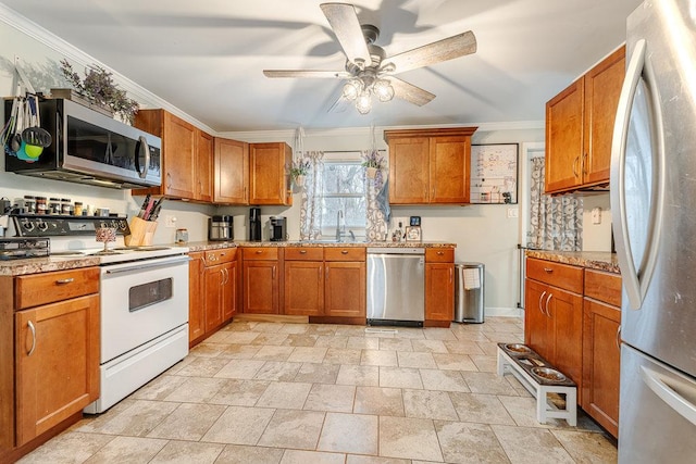 kitchen featuring sink, ceiling fan, ornamental molding, light stone counters, and stainless steel appliances