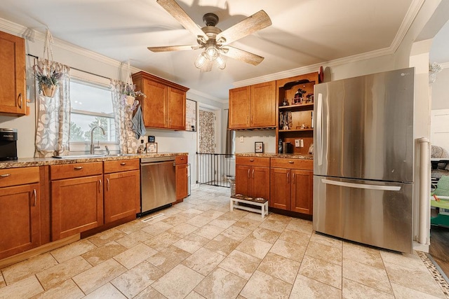 kitchen featuring sink, ceiling fan, light stone countertops, ornamental molding, and appliances with stainless steel finishes