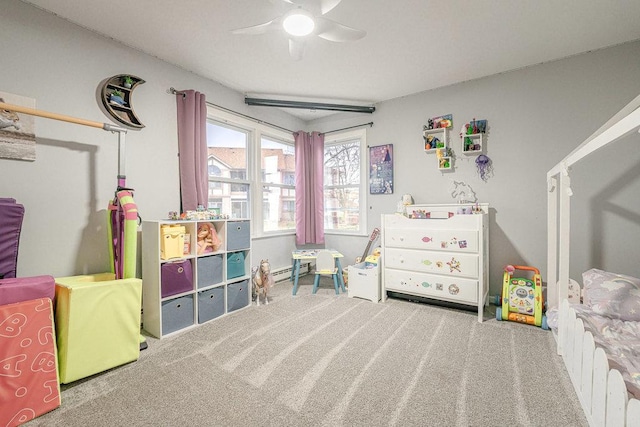 bedroom featuring carpet flooring, ceiling fan, and a baseboard heating unit