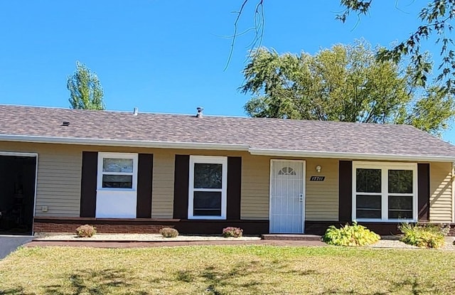 ranch-style home with a front yard and a porch