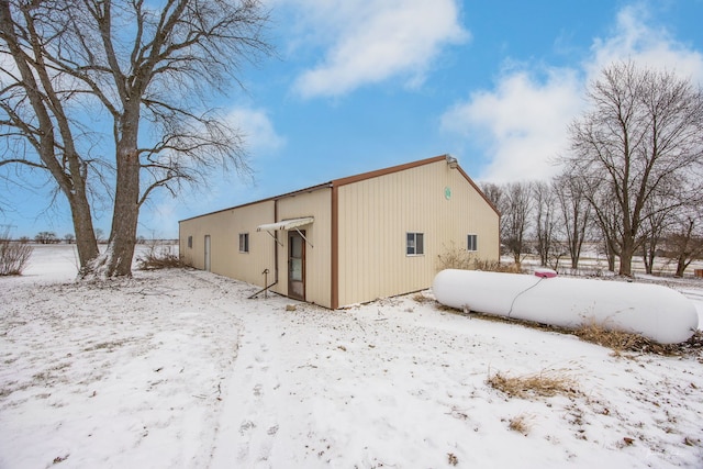 view of snow covered exterior with a garage