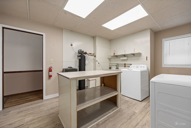 laundry room with light wood-style floors, laundry area, and baseboards