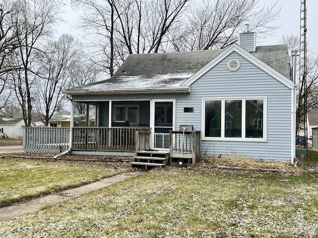 view of front of house featuring a front yard and a sunroom