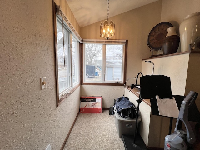 interior space featuring carpet, a chandelier, and lofted ceiling