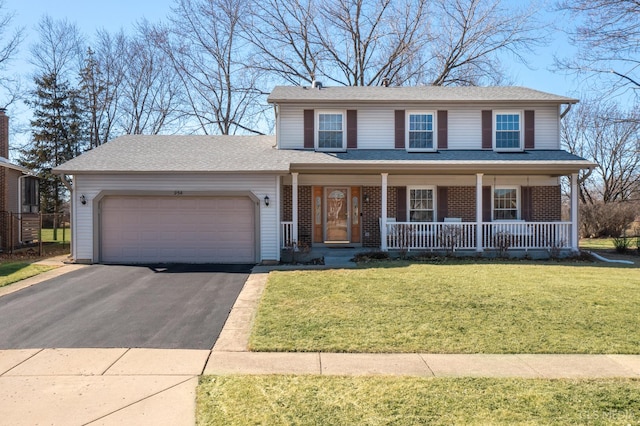 view of front of house with aphalt driveway, brick siding, a porch, an attached garage, and a front yard