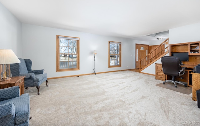 office space featuring a wealth of natural light, carpet flooring, and baseboards