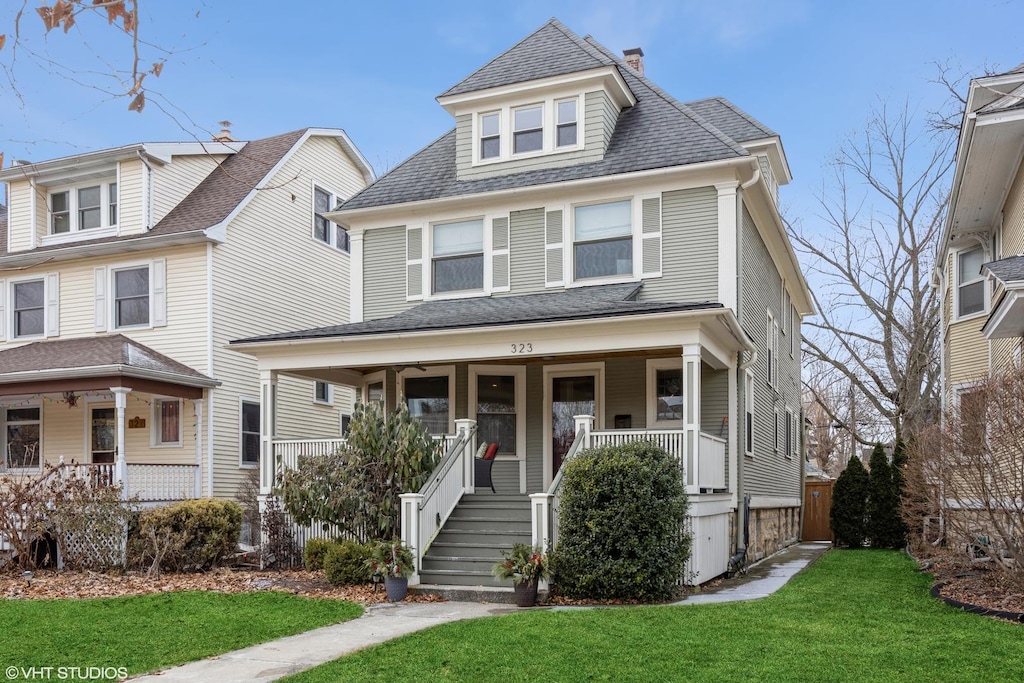 view of front of property with covered porch and a front lawn