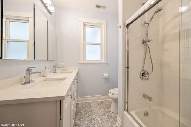 full bathroom featuring enclosed tub / shower combo, vanity, and toilet