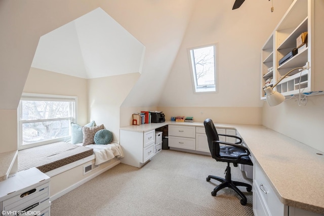 carpeted office space with lofted ceiling and ceiling fan