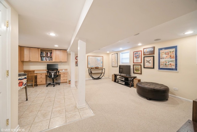 office area with built in desk and light carpet