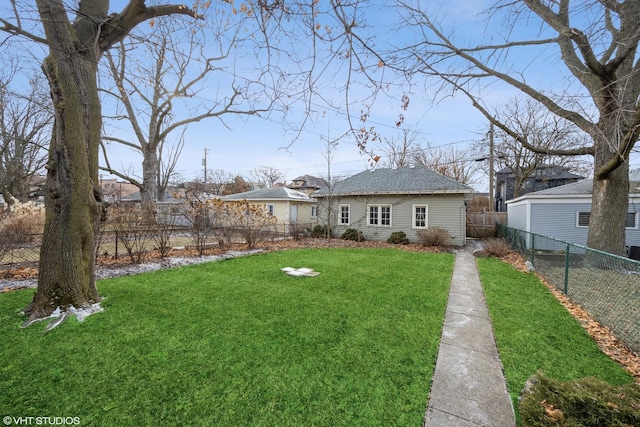 rear view of house featuring a yard