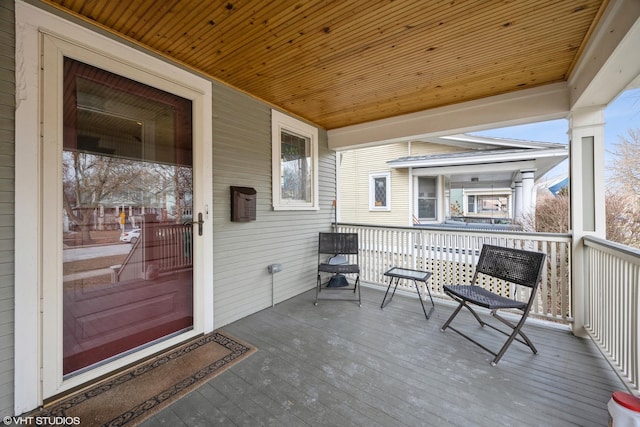 wooden terrace featuring covered porch