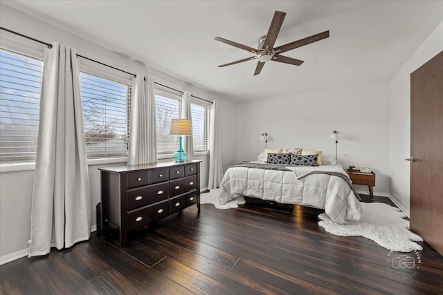 bedroom with ceiling fan and dark wood-type flooring