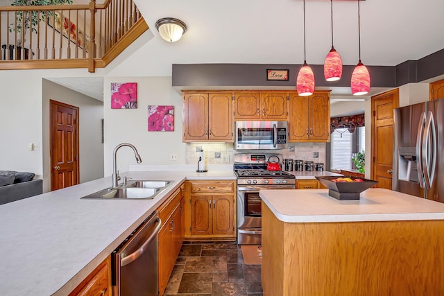 kitchen with decorative backsplash, stainless steel appliances, sink, a kitchen island, and hanging light fixtures