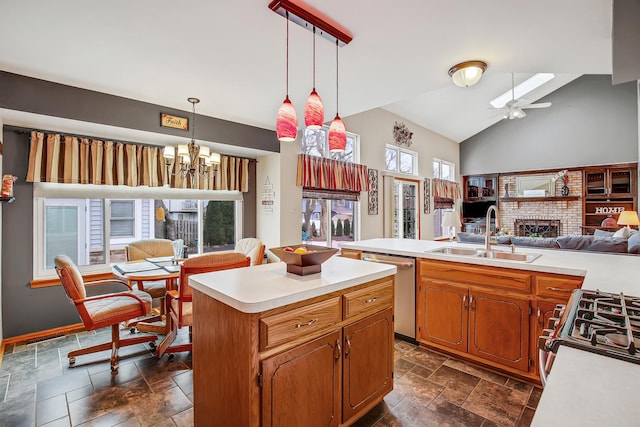 kitchen featuring sink, a kitchen island, stainless steel appliances, and plenty of natural light