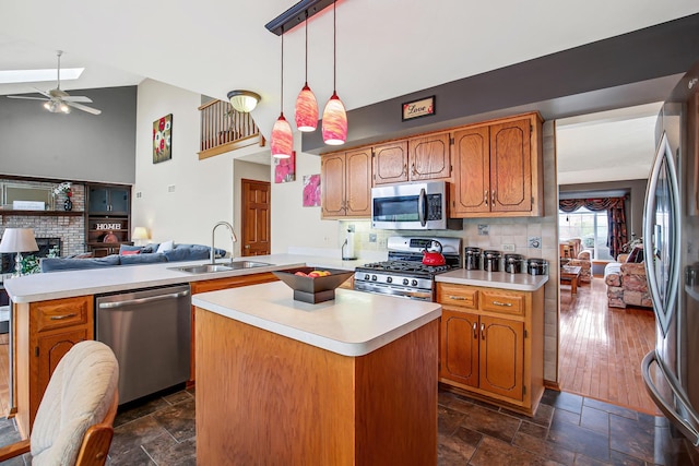 kitchen featuring sink, a center island, pendant lighting, and appliances with stainless steel finishes