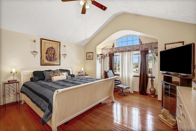 bedroom featuring ceiling fan, wood-type flooring, and vaulted ceiling