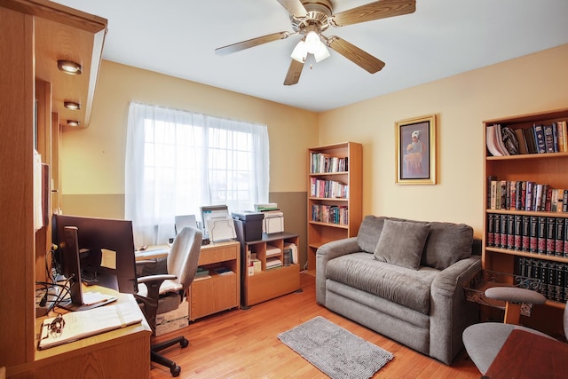 office with ceiling fan and light hardwood / wood-style floors