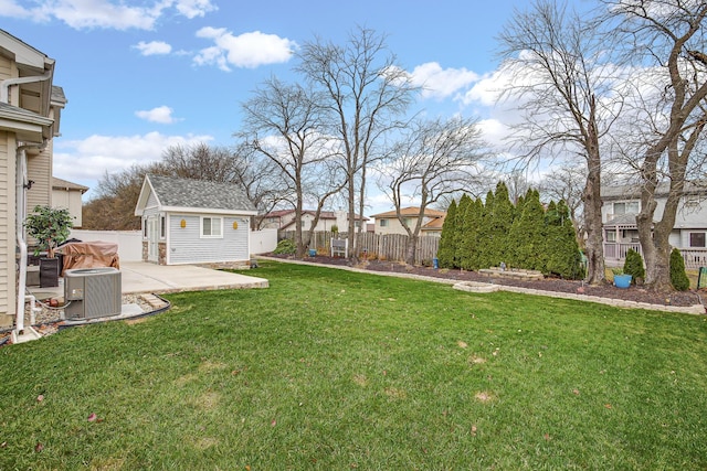 view of yard with an outdoor structure, a patio area, and central air condition unit