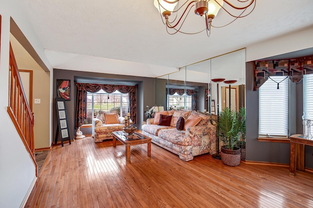 living room with hardwood / wood-style floors and an inviting chandelier