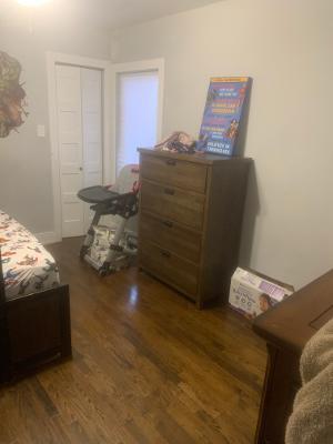 bedroom with dark hardwood / wood-style flooring and a closet