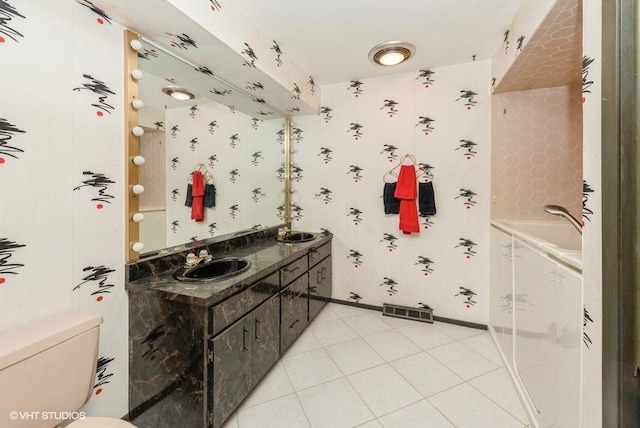 bathroom featuring tile patterned flooring, vanity, and toilet