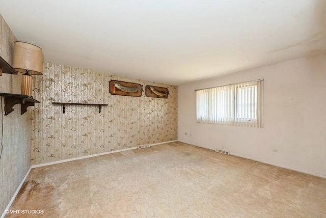 spare room featuring light colored carpet