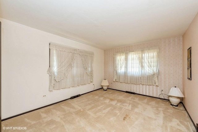 empty room with light colored carpet