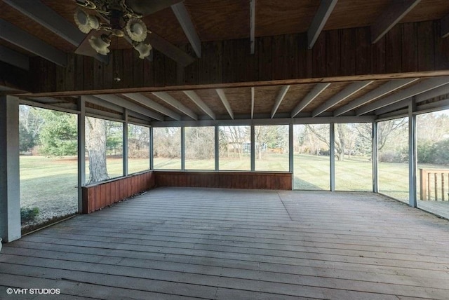 unfurnished sunroom with ceiling fan