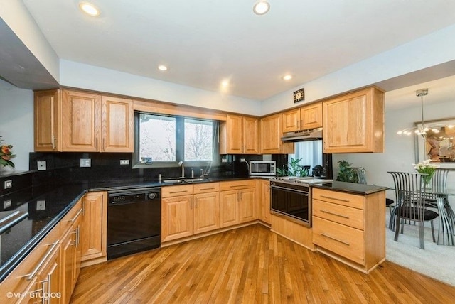 kitchen with sink, decorative light fixtures, black dishwasher, a notable chandelier, and range