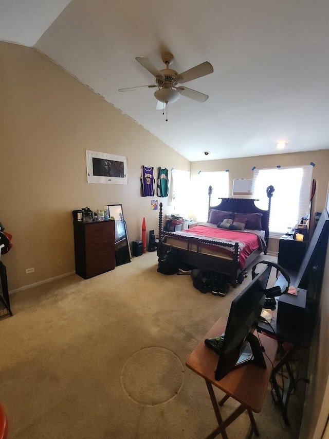 carpeted bedroom with ceiling fan and vaulted ceiling