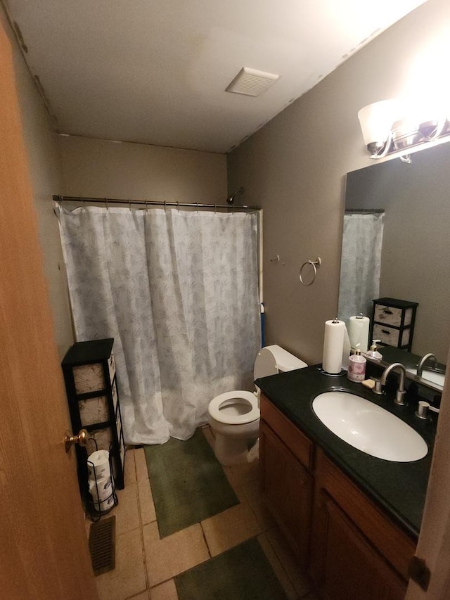 bathroom featuring toilet, vanity, and tile patterned floors