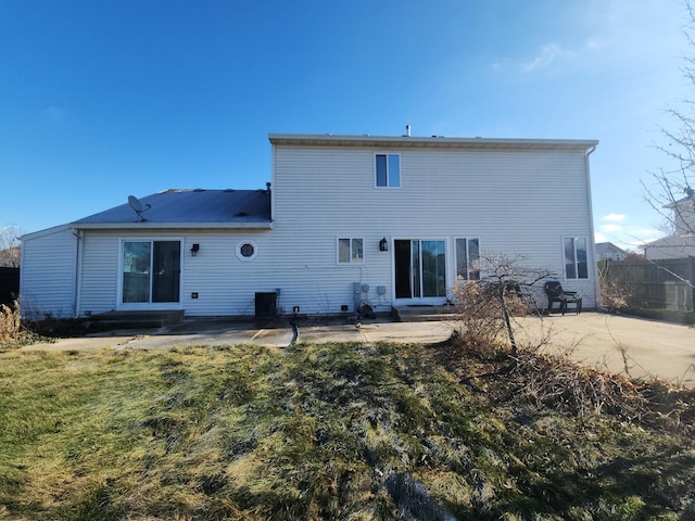 rear view of house with a lawn and a patio